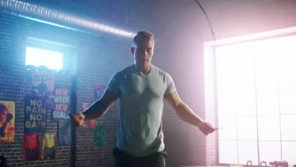 Masculine Athletic Young Man Exercises with Jumping Rope in a Loft Style Industrial Gym. He's Doing His Intense Cross Fitness Training Program. Facility has Motivational Posters on the Wall. — Stock Footage Masculine Athletic Young Man Exercises with Jumping Rope in a Loft Style Industrial Gym. He's Doing His Intense Cross Fitness Training Program. Facility has Motivational Posters on the Wall. Royalty Free Stock Video