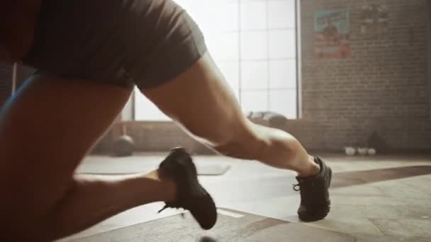 Sterk en fit atletische vrouw in sport top en shorts doet Mountain Climber oefeningen in een loft-stijl industriële Gym met motiverende posters. Het maakt deel uit van haar cross Fitness Training workout. — Stockvideo