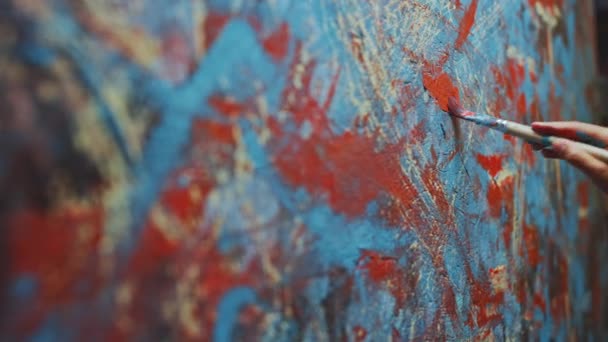 Close-up Shot of Female Artist Hand, Holding Paint Brush and Drawing Painting with Red Paint. Colorful, Emotional Oil Painting. Contemporary Painter Creating Modern Abstract Piece of Fine Art — Stock Video