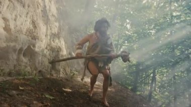 Hayvan Derisi Giyen Primeval Caveman Tutar Taş Uçlu Çekiç Etrafına Bakar, Prehistorik Ormanı Keşfetmek, Hayvan Avı'na Hazır. Neandertal Ormana Avlanmaya Gidiyor. Çekimden Sonra