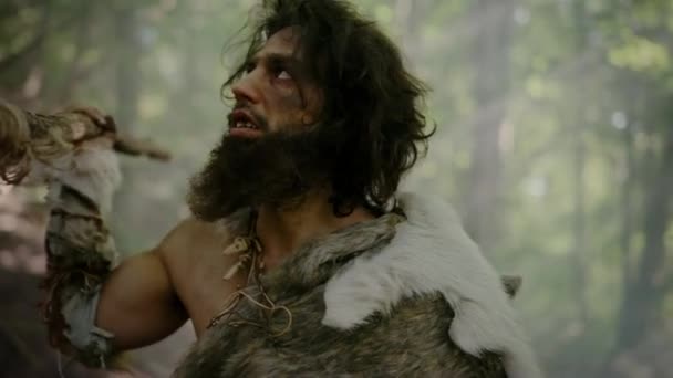 Portrait of Primeval Caveman Wearing Animal Skin and Fur Hunting with a Stone Tipped Spear in the Prehistoric Forest. Prehistoric Neanderthal Sneaking Ready to Throw Spear into Animal — Stock Video