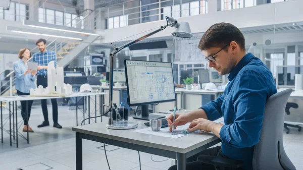 In Architectural Bureau: Team of Architects and Engineers Working on a Building Complex Prototype Project, Using City Model and Computers Running 3D CAD Software. Residential or Business District