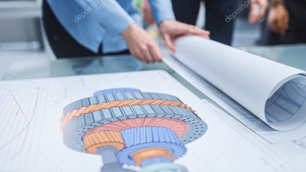In the Industrial Engineering Facility: Diverse Group of Engineers and Technicians on a Meeting Gather Around Table Unravel Sheets of Engine Design Technical Drafts, Have Discussion, Analyse Drawings