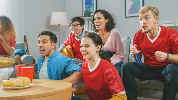 At Home Diverse Group of Sports Fans Wearing Team's Uniform Watch Sports Game Match on TV, They Cheer for the Team, Celebrate Victory after Team Scores a Winning Goal. Cozy Room with Snacks and Drinks — Stock Photo, Image