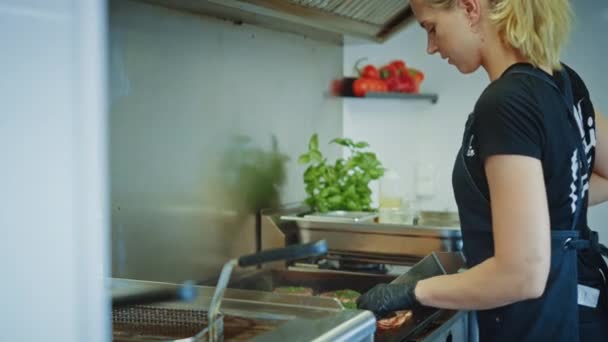 Back Shot of a Young Beautiful Girl Cooking and Prepairing Meat Patty on a Griller. Carnea de vită proaspăt măcinată este la grătar pe un grătar cu gaz cald sau electric. Gustos Burger cu Suculent Minced Meat . — Videoclip de stoc