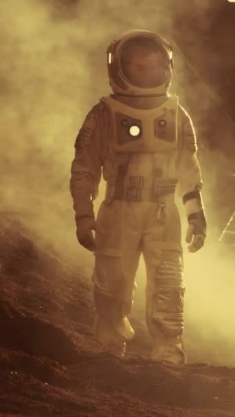 Astronauta em Marte Caminhando na Expedição Explorando. Em segundo plano sua base / estação de pesquisa. Primeira missão tripulada a Marte. Exploração Espacial. Filmagem de vídeo com orientação vertical da tela 9: 16 — Vídeo de Stock