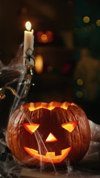 Halloween Still Life Colorful Theme: Scary Decorated Dark Room with Burning Pumpkin Head with Candlestick Inside. Background: Silhouette of Monster Walking. Vertical Screen Orientation Video 9:16 — Stock Video