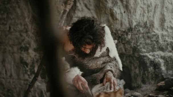 Primeval Caveman Wearing Animal Skin Holds Sharp Stone and Makes First Primitive Tool for Hunting Animal Prey, or to Handle Hides. Neanderthal Using Handax. Dawn of Human Civilization — Stock Video