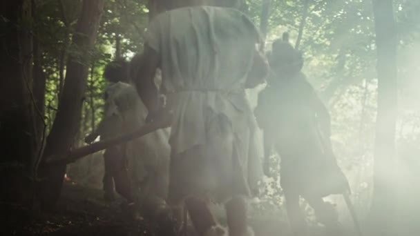 Tribe of Hunter-Gatherers Wearing Animal Skin Holding Stone Tipped Tools, Explore Prehistoric Forest in a Hunt for Animal Prey. Neanderthal Family Hunting in the Jungle or Migrating for Better Land — Stock Video