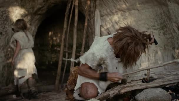 Primeval Caveman Wearing Animal Skin Trying to make a Fire with Bow Drill Method. Neanderthal Kindle First Man-Made fire in the Human Civilization History. Making Fire for Cooking. Zoom In Shot — Stock Video