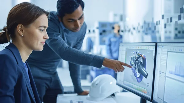 " In Factory Workshop: Professional Workers Use High-Tech Industrial CNC Machinery, Robot Arm. Inside Office: Male Project Supervisor Talks to a Female Industry 4 Engineer who Works on Computer, Talk" — Stock Photo, Image