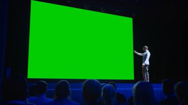 Keynote Sözcüsü Yeni Ürün Sunumunu Seyirciye Yapıyor, Ardında Yeşil Ekran, Model, Kroma Anahtarlı Sinema Salonu. İş Konferansı Canlı Olay veya Aygıt Açıklaması