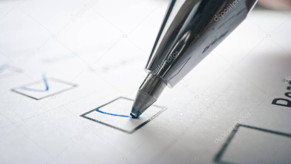 Person Ticks Checkbox Marks with a Pen, filling up To Do List. Checking Marks and FIlling in a Task List Questiannaire Medical Cart. Moving Macro Close-up Camera