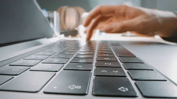 Person Typing on the Laptop Keyboard. Working, Writing Emails, Using Internet. Notebook lying on the Tablet, Bright Sunny day in the Background. Close-up Macro Shot — Stock Photo, Image