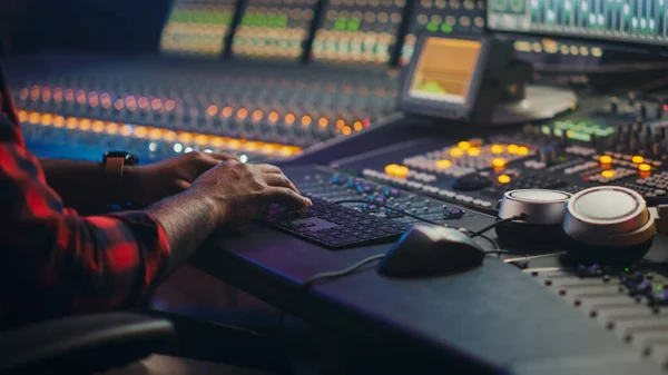 Music Creator, Musician, Artist Works in the Music Record Studio, Uses Surface Control Desk Equalizer Mixer. Buttons, Faders, Sliders to Broadcast, Record, Play Hit Song. Close-up Focus on Hands