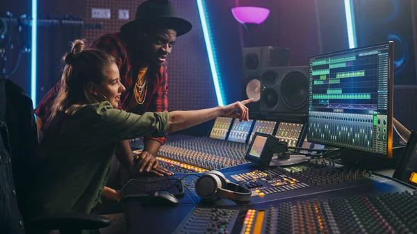 Producer and Professional Audio Engineer Working together in Music Recording Studio on a New Album, Talk, Use Control Desk Equalizer, Mixing Board and Software to Create Hit Song. Artist and Musician — Stock Photo, Image