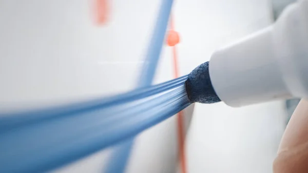 Macro Shot of a Blue Marker Pen Being Held with a Hand. Person Drawing a Blue Line on a Whiteboard. — Stock Photo, Image