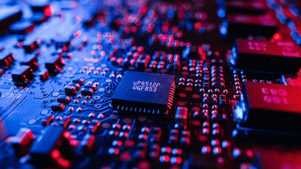 Close-up Macro Shot of Microchip, CPU Processor, Printed Circuit Board or Computer Motherboard with Components: Inside of Electronic Device. Neon Colors. Cyber Security Safety Concept. Royalty Free Stock Images