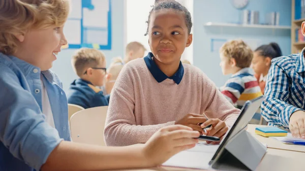 In the Elementary School: Girl and a Boy Work as a Team Using Tablet Computers, Learning Programming Language, Internet Safety and Robotics Design. Progressive Education System