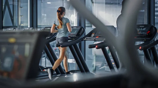 Sport athlétique Femmes Courir sur un tapis roulant. Entraînement énergique pour athlètes féminines dans la salle de sport. Club de conditionnement physique féminin seulement pour l'entraînement et l'entraînement. Vue arrière — Photo