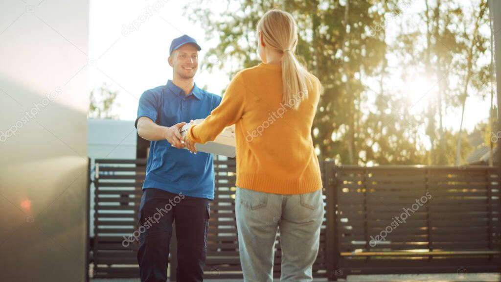 Beautiful Young Woman Meets Delivery Man who Gives Her Cardboard Boxes Full of Hot Tasty Pizzas. Courier Delivering Food in the Suburban Neighborhood to a Happy Girl