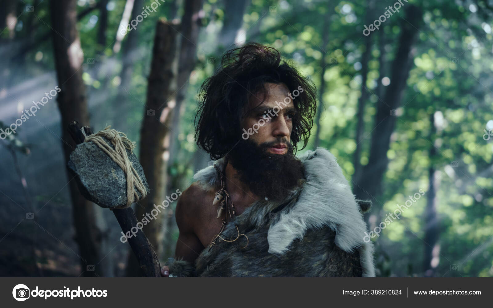 Portrait of Primeval Caveman Wearing Animal Skin and Fur Hunting with a