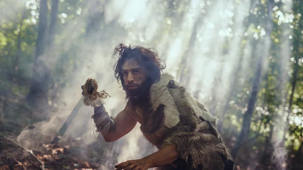 Portrait of Primeval Caveman Wearing Animal Skin and Fur Hunting with a Stone Tipped Spear in the Prehistoric Forest. Prehistoric Neanderthal Hunter Scavenging with Primitive Tools in the Jungle — Stock Photo, Image