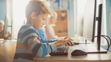 İlköğretim Okulu Sınıfı: Akıllı Çocuk Kişisel Bilgisayar Kullanıyor, İnterneti Güvenli Kullanmayı Öğreniyor, Yazılım Kodlaması İçin Programlama Dili. Modern eğitim alan okul çocukları. Portre Çekimi