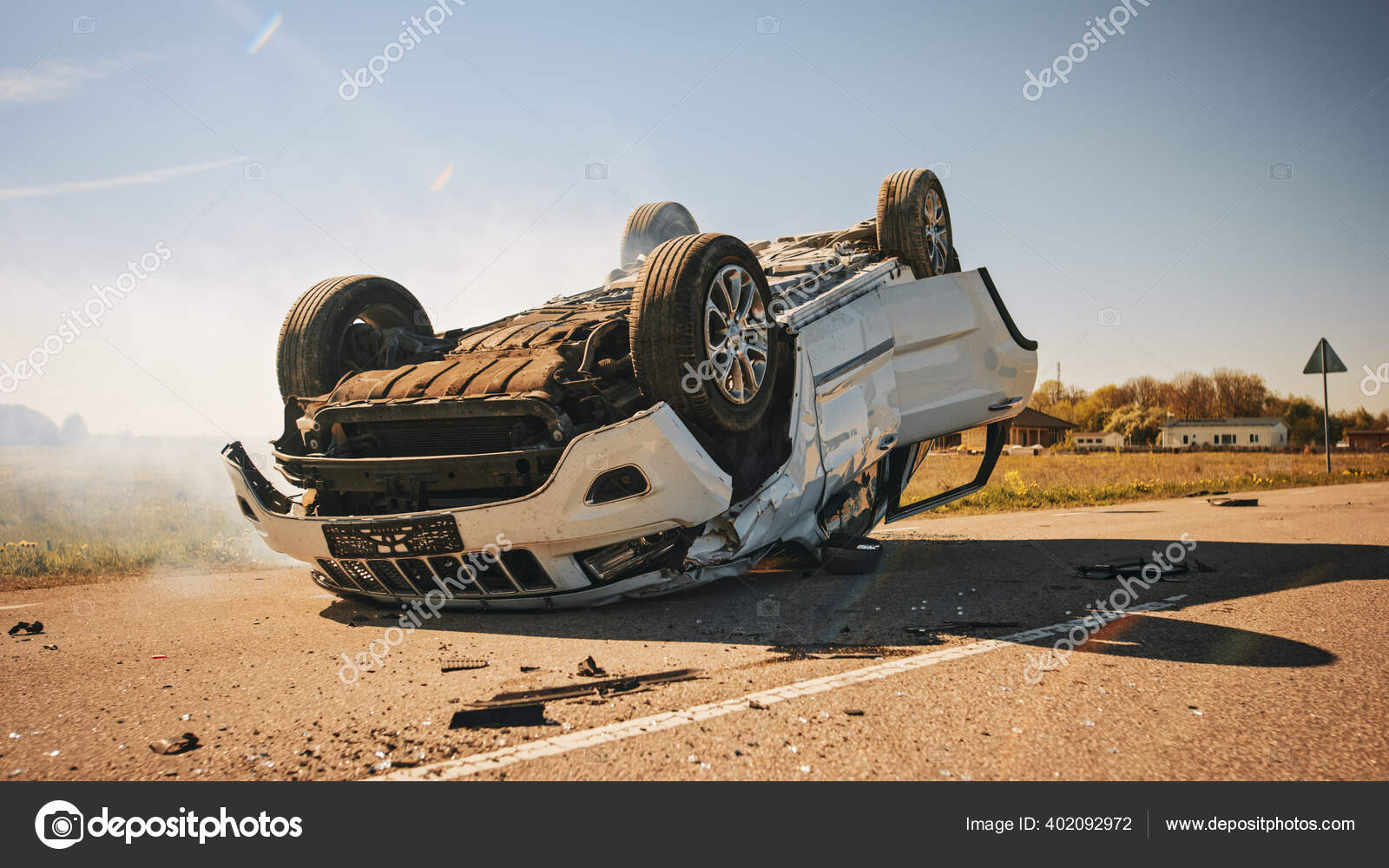 Horrific Traffic Accident, Rollover Smoking and Burning Vehicle Lying on its Roof in the Middle