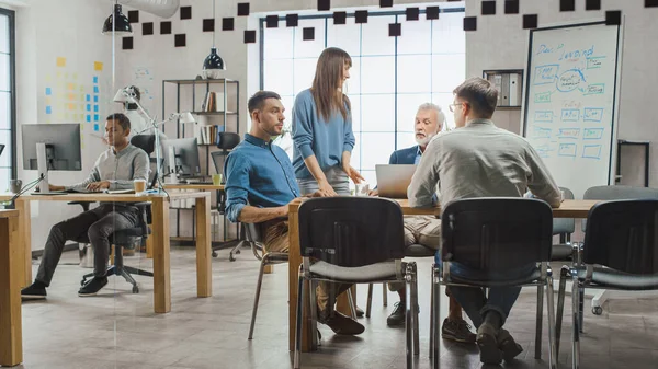 In the Stylish Open Space Office: Diverse Group of Enthusiastic Business Marketing Professionals Use Computers, Have Meetings, Discussing Project Ideas, Brainstorming Startup Company Strategy — Stock Photo, Image