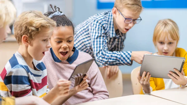 School Computer Science Class: Schoolchildren Use Digital Tablet Computers and Smartphones with Augmented Reality Software, They re Excited, Full of Wonder. Children in STEM, Playing and Learning — Stock Photo, Image