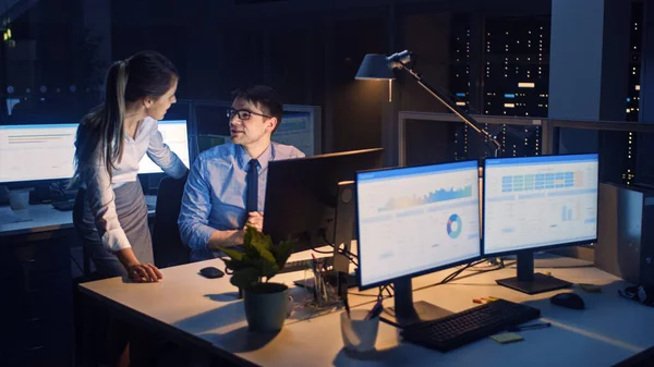 Late at Night in Modern Office: Office Worker Sitting and Working at His Desktop Computer, Discusses Problem Solution wit Project Manager, They Look at Each Other. — Stock Photo, Image