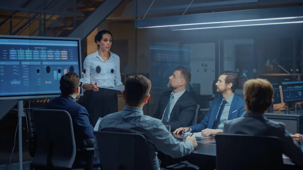 In the Corporate Meeting Room: Female Executive Talks and Uses Digital Interactive Whiteboard for Presentation to a Board of Directors, Investors. Screen Shows Growth Data. Late at Night Office — Stock Photo, Image