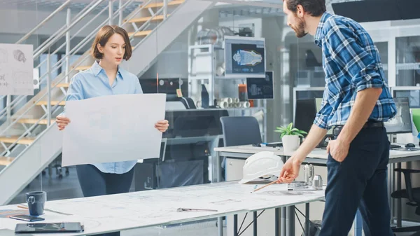 In the Industrial Engineering Facility: Female Architect Prints Drafts of Industrial Engine Prototype and Brings Them to Chief Engineer, Start Discussion and Analysis Using Conference Table.