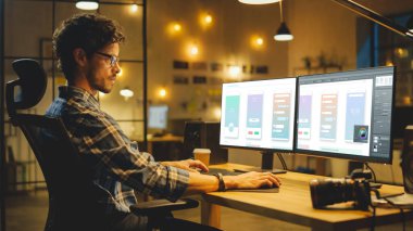 Late Evening Creative Office: Professional Programmer Works on a Desktop Computer, Creating Phone App Design, using Monting Software. Modern Moda Ofis Ortamı