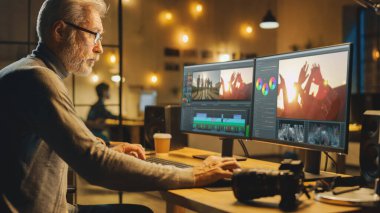 Yaratıcı Ofiste Akşam: Profesyonel Ortaçağ Videografisi Masaüstü Bilgisayarında Çalışıyor, Video Montaj Yapıyor, Video Düzenleme Yazılımını Kullanıyor. Modern Video Geliştiriciler Ofisi