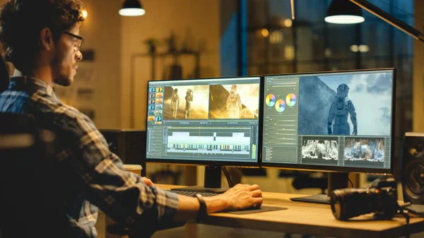 Late Evening Creative Office: Professional Videographer Works on Desktop Computer, Doing Footage Montage, using Video Editing Software. Modern Video Geliştiriciler Ofisi