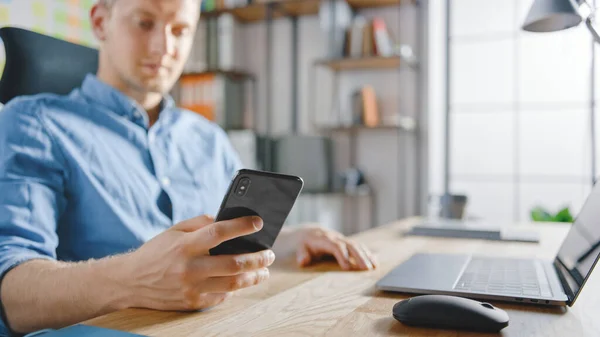 Businessman Sitting at His Desk Works on Desktop Computer in the Stylish Office, Picks up and Starts Using Smartphone, Uses Social Media App, Emailing Business Partners, Messaging — Stock Photo, Image