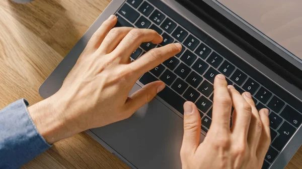 Top View Close-up Shot of a Mans Hands Typing on a Laptop Keyboard. Bright and Modern Theme. — Stock Photo, Image