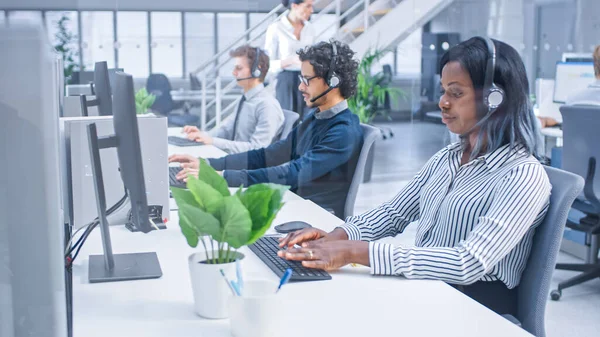 Team of Handsome and Beautiful Diverse Multicultural Customer Service Operators Working at a Busy Modern Call Center with Specialists Wearing Headsets and Actively Taking Calls. — 스톡 사진