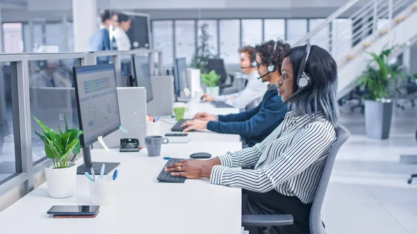 Team of Handsome and Beautiful Diverse Multicultural Customer Service Operators Working at a Busy Modern Call Center with Specialists Wearing Headsets and Actively Taking Calls. — 스톡 사진