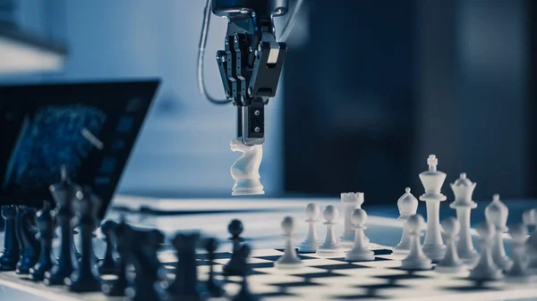 Fermer Plan vertical de l'intelligence artificielle Exploiter un bras robotique futuriste dans un jeu d'échecs. Robot déplace un chevalier. Laboratoire de recherche moderne de haute technologie. — Photo