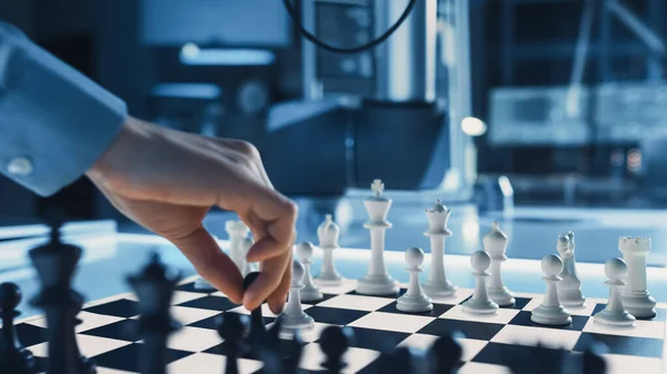 Close Up Shot of a Artificial Intelligence Operating a Futuristic Robotic Arm in a Game of Chess Against a Human. Male Moves a Pawn. They are in a High Tech Modern Research Laboratory. — Stock Photo, Image
