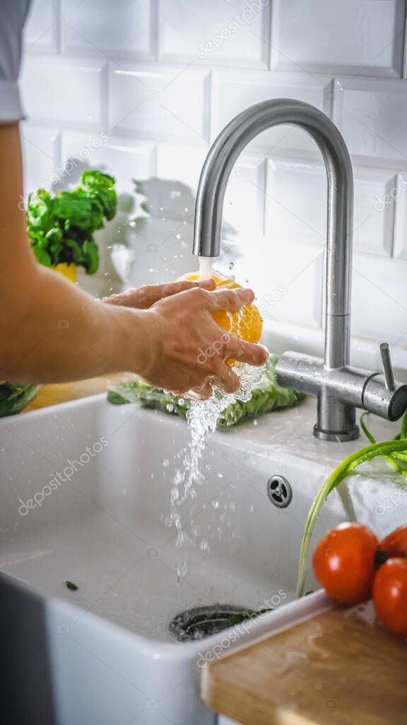 Close Up Shot of a Person Washing Yellow Sweet Pepper with Tap Water. Authentic Stylish Kitchen with Healthy Vegetables. Natural Clean Products from Organic Farming Washed by Hand.