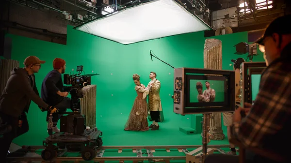 On Big Film Studio Professional Crew Shooting Period Costume Drama Movie. On Set: Director Controls Cameraman Shooting Green Screen Scene with Two Actors Talented Wearing Renaissance Clothes Talking — Stock Photo, Image