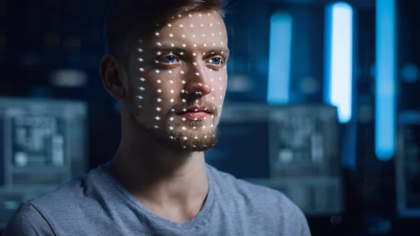 Handsome Young Caucasian Man is Identified by Biometric Facial Recognition Scanning Process. Futuristic Concept: Projector Identifies Individual by Illuminating Face by Dots and Scanning with Laser