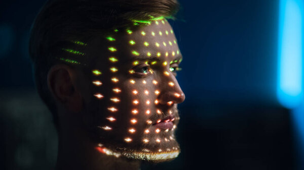 Handsome Young Caucasian Man is Identified by Biometric Facial Recognition Scanning Process. Futuristic Concept: Projector Identifies Individual by Illuminating Face by Colorful Dots and Laser — Stock Photo, Image