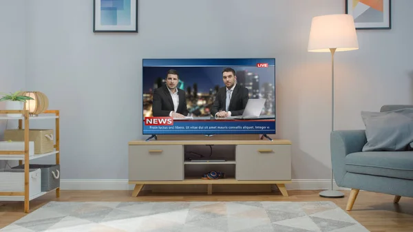 Shot of a TV with Live News Channel. Cozy Living Room at Day Time with a Chair and Lamps Turned On at Home.