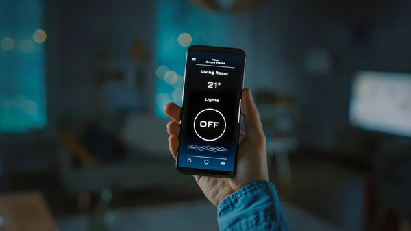 Close Up Colpo di smartphone con applicazione Active Smart Home. La persona sta dando un comando vocale per accendere le luci nella stanza. La sua sera accogliente in appartamento. — Foto Stock