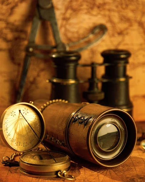 Old telescope with binoculars on map background